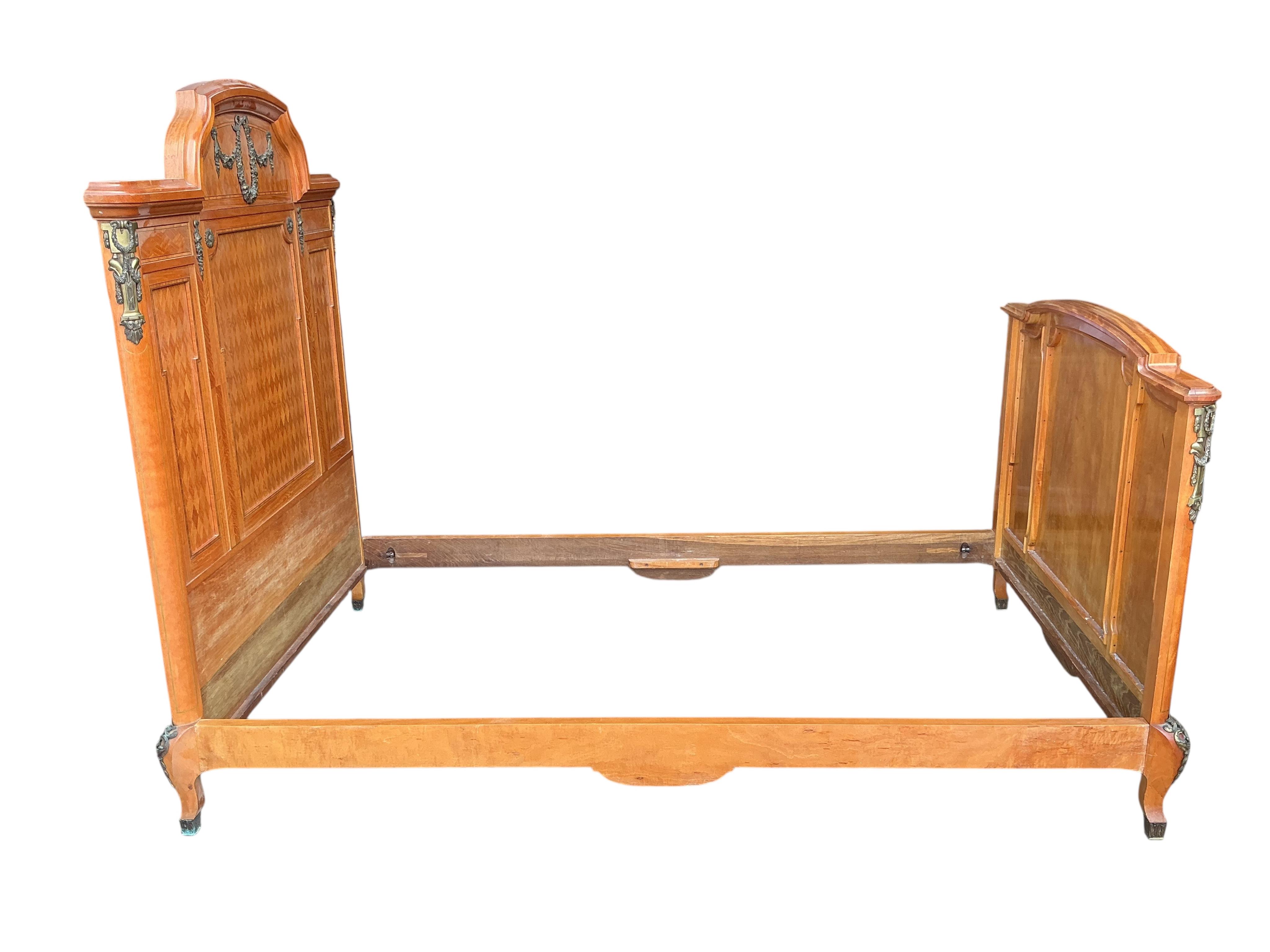 A pair of early 20th century French transitional style gilt metal mounted parquetry inlaid 4ft. bedframes, height 150cm
